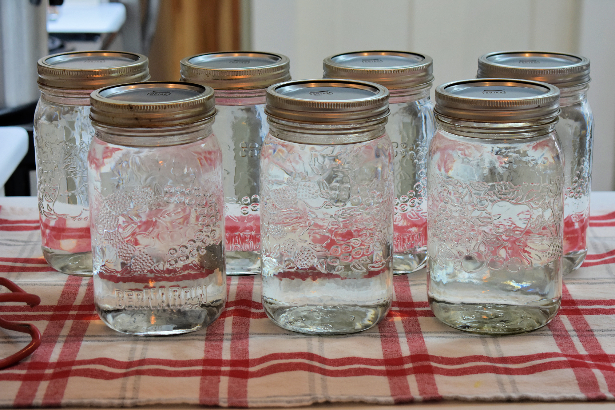 Mason jars of canned water. | How to Can Water for Emergencies