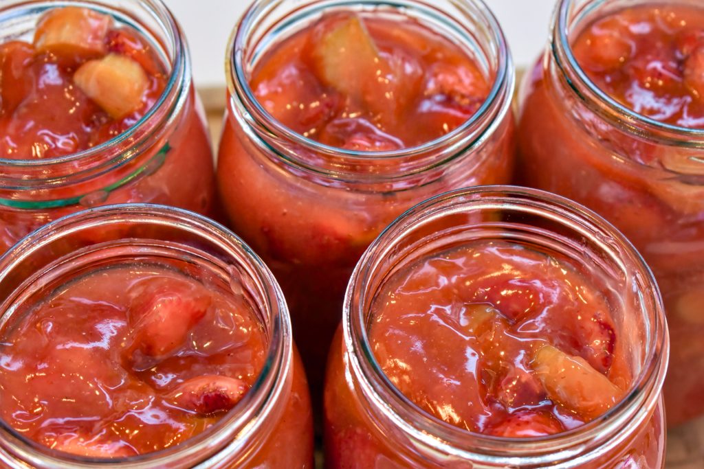 A top-down view of mason jars filled with strawberry rhubarb pie filling