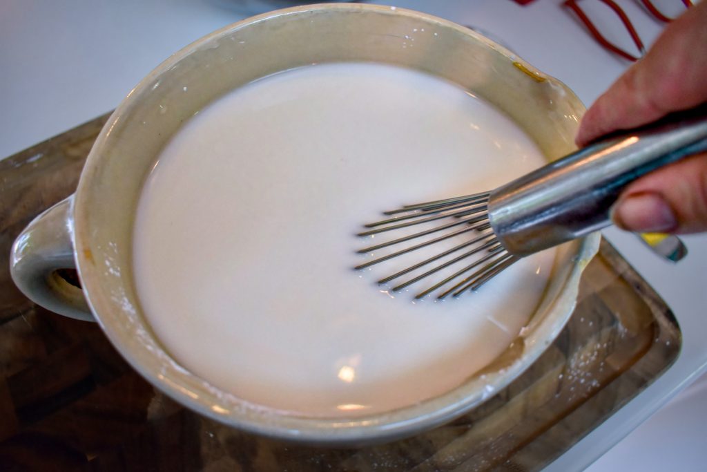 A whisk in a mixture of water and dissolved Clear Jel