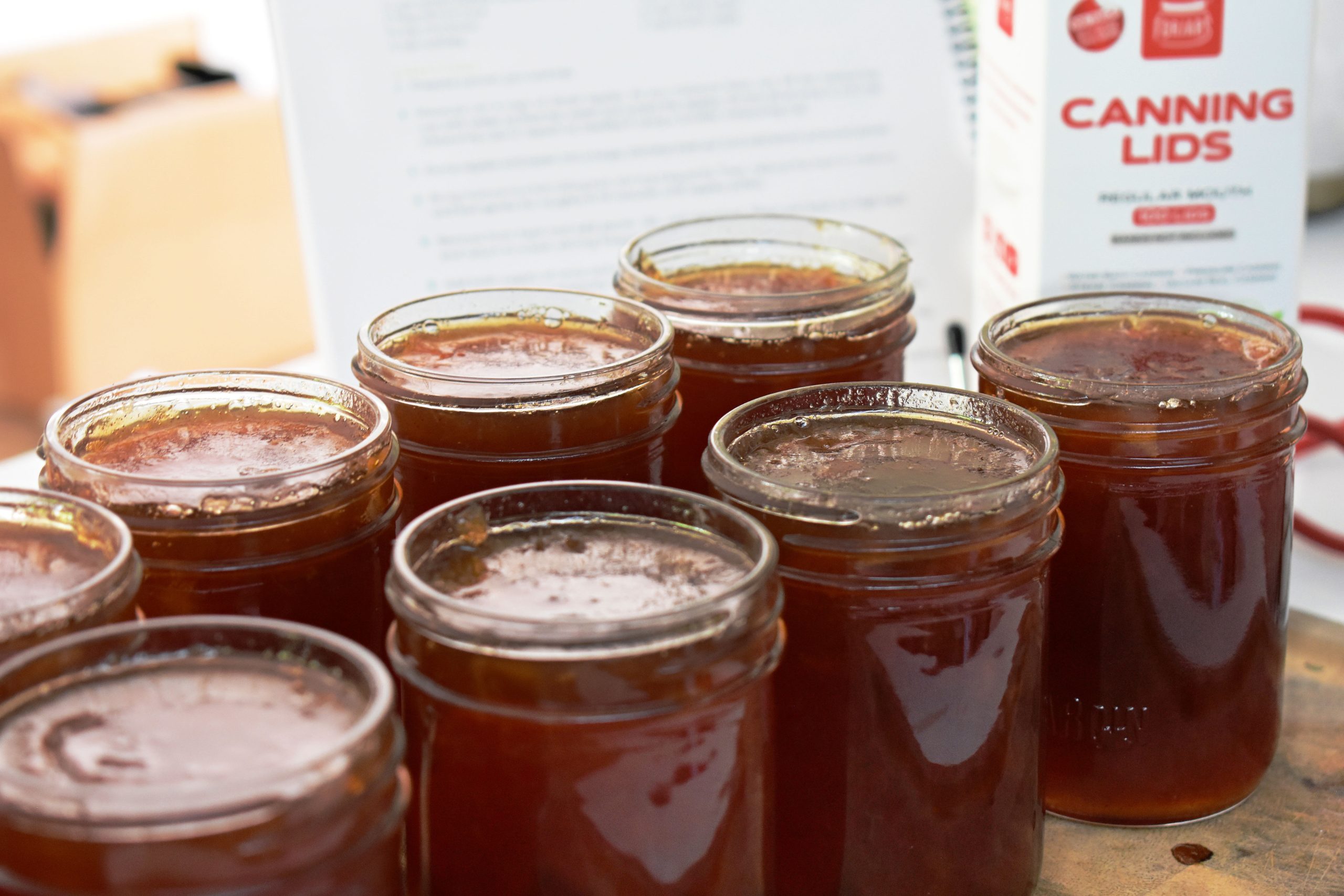 Jars of freshly-made apple pie jam with the lids still off, waiting to be canned.