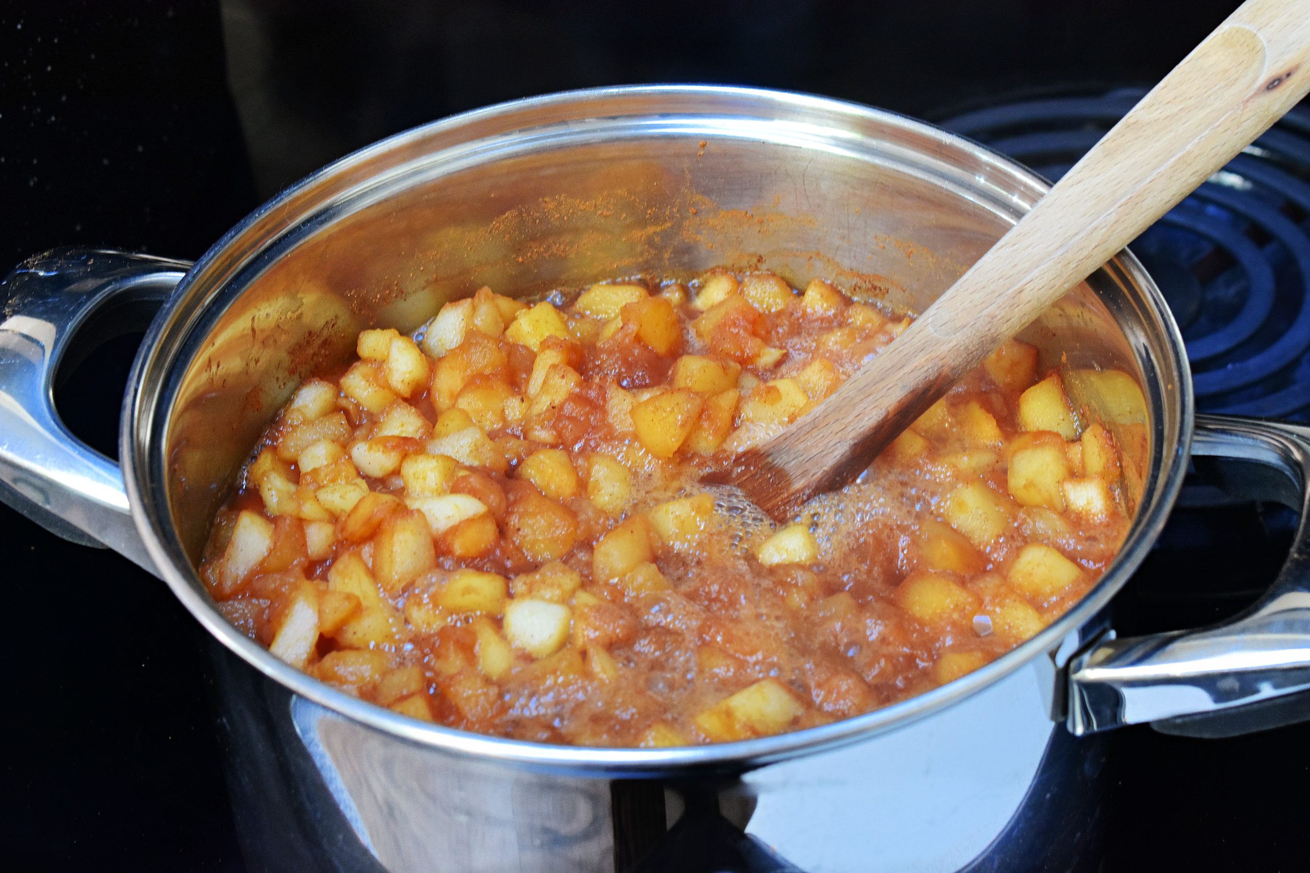 Cooking apple pie jam in a pot.